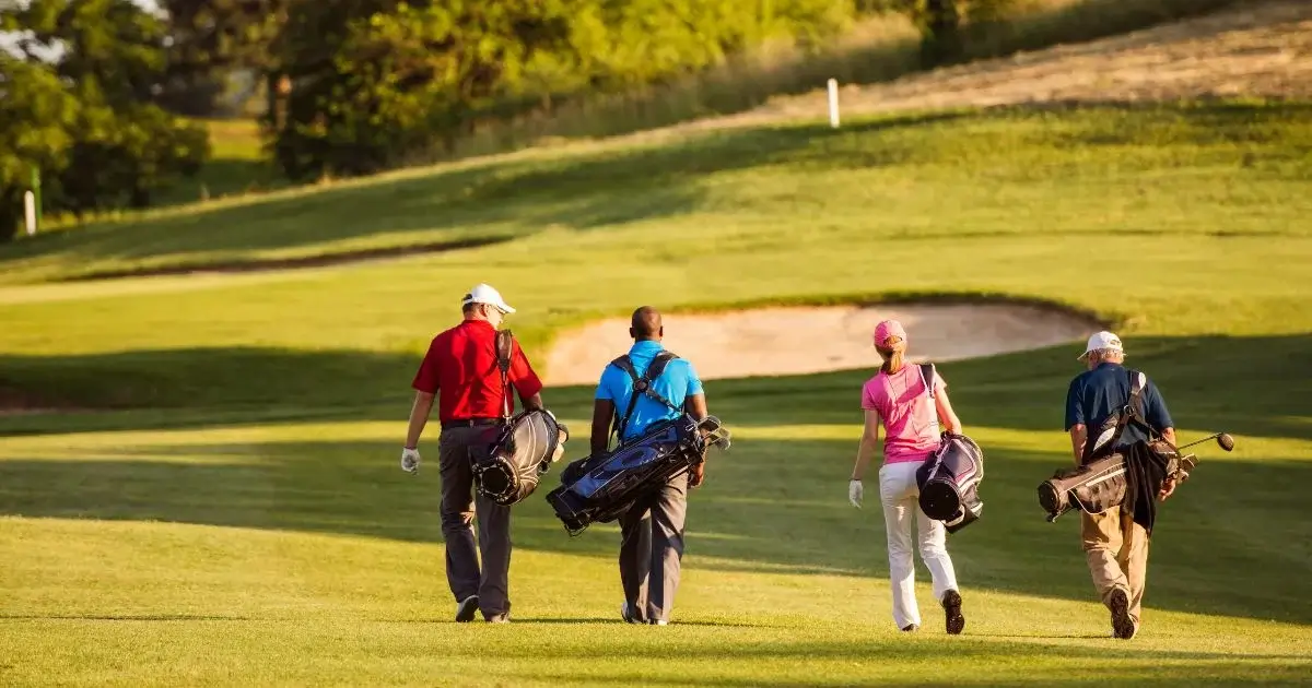 Golfers walking fairway during group outing